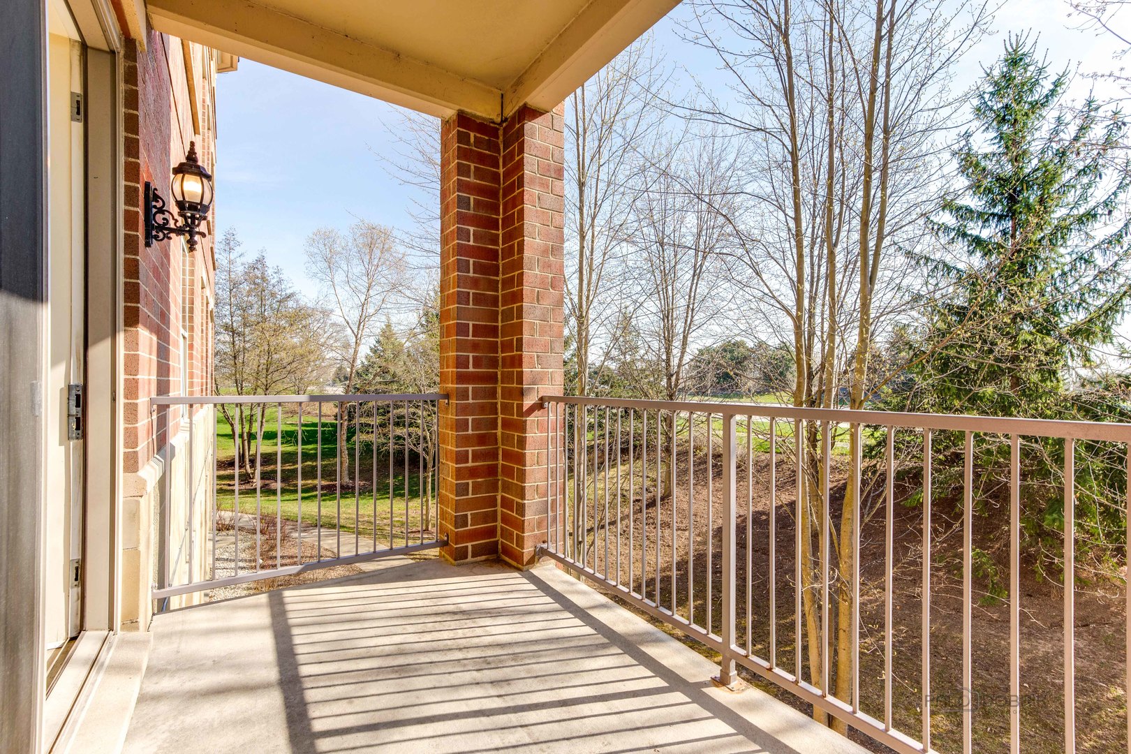 2700 Summit Drive, Unit 209 Glenview, IL 60025 - Photo 22 of 23 a view of a balcony with a floor to ceiling window and wooden fence