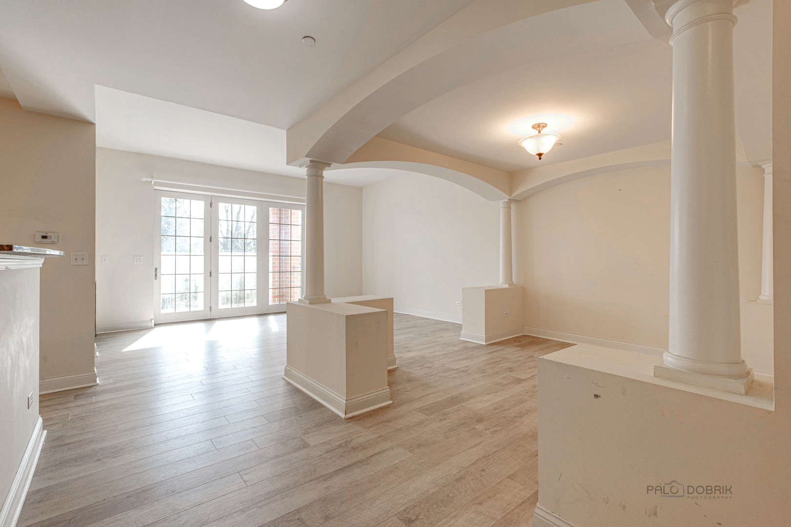 2700 Summit Drive, Unit 209 Glenview, IL 60025 - Photo 3 of 23 wooden floor in an empty room with a window