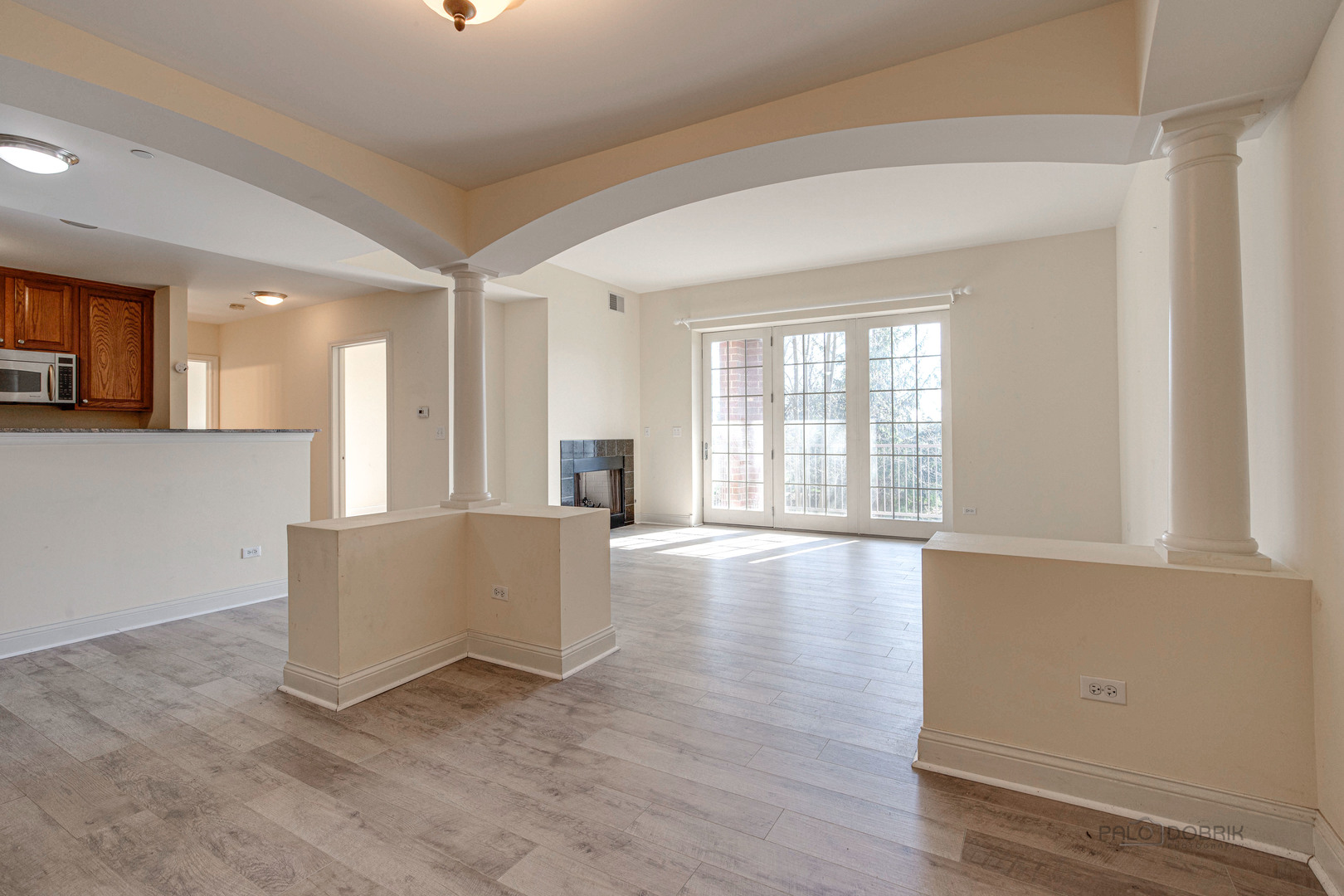 2700 Summit Drive, Unit 209 Glenview, IL 60025 - Photo 5 of 23 an empty room with wooden floor and windows