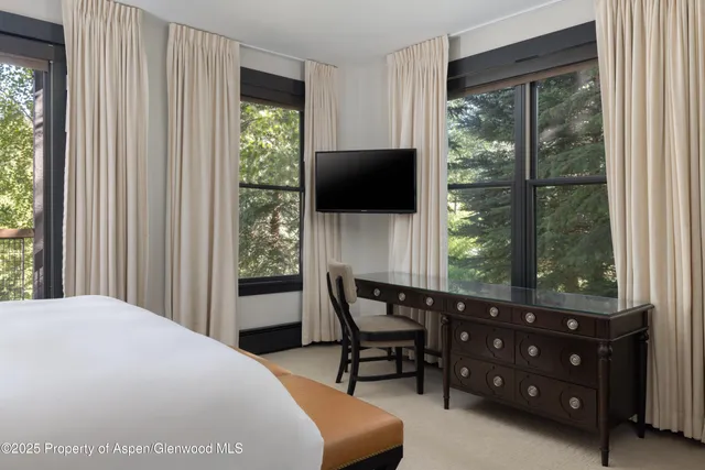 a bedroom with a bed and a chair