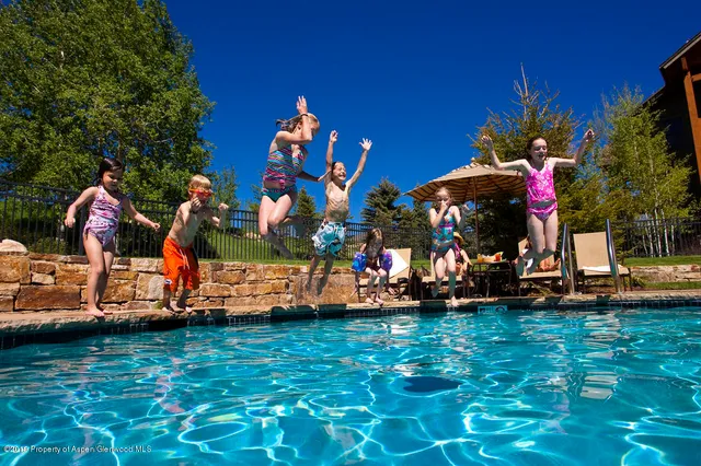 a group of people sitting in a yard