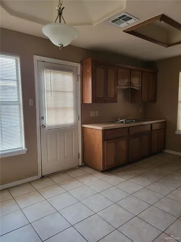 a kitchen with stainless steel appliances a sink and cabinets