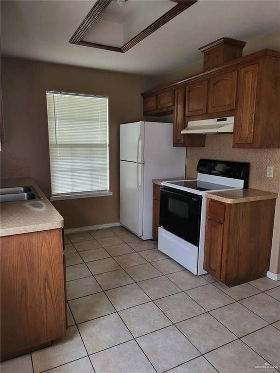 1507 East Coyote Street, Unit C Pharr, TX 78577 - Photo 13 of 16 a kitchen with a stove a microwave and a refrigerator