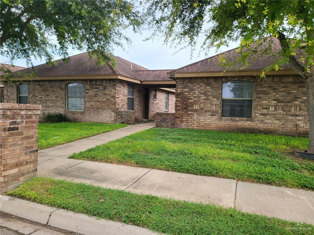1507 East Coyote Street, Unit C Pharr, TX 78577 - Photo 3 of 16 a front view of a house with a yard and garage
