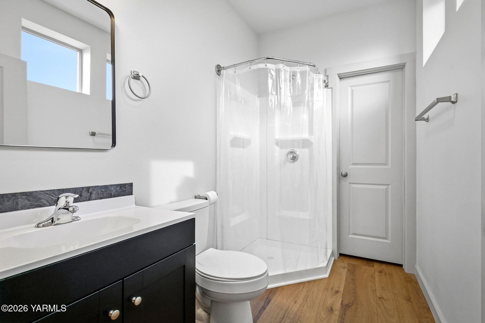 801 South 16th Avenue, Unit 4 Yakima, WA 98902 - Photo 12 of 22 a bathroom with a sink a toilet a mirror and shower