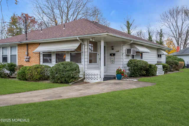 a front view of a house with a yard and porch