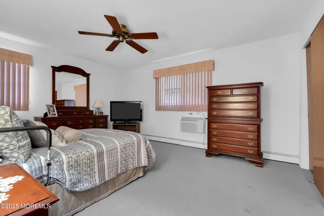 a bedroom with a bed and a television