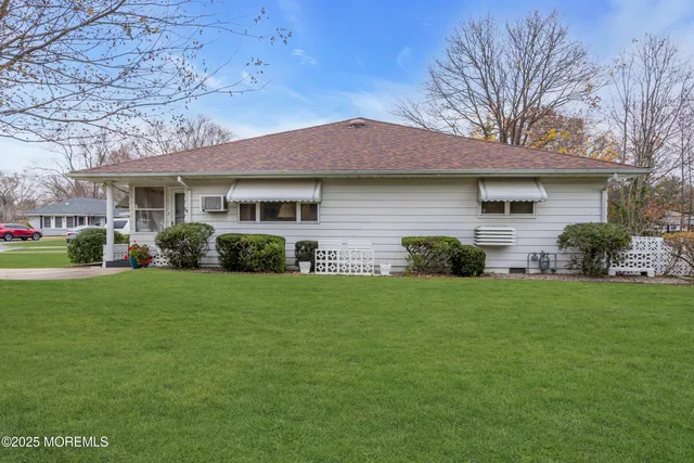 a front view of house with yard and green space