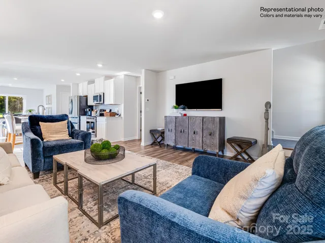 a kitchen with stainless steel appliances kitchen island granite countertop a stove top oven a sink a dining table and chairs with wooden floor