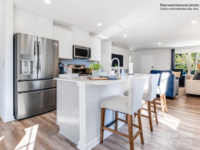 a kitchen with stainless steel appliances granite countertop lots of counter space and a sink