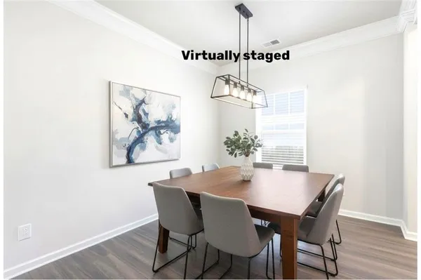 a view of a dining room with furniture and wooden floor