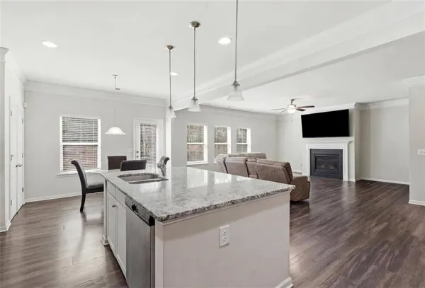 a open kitchen with stainless steel appliances granite countertop a stove and a wooden floor