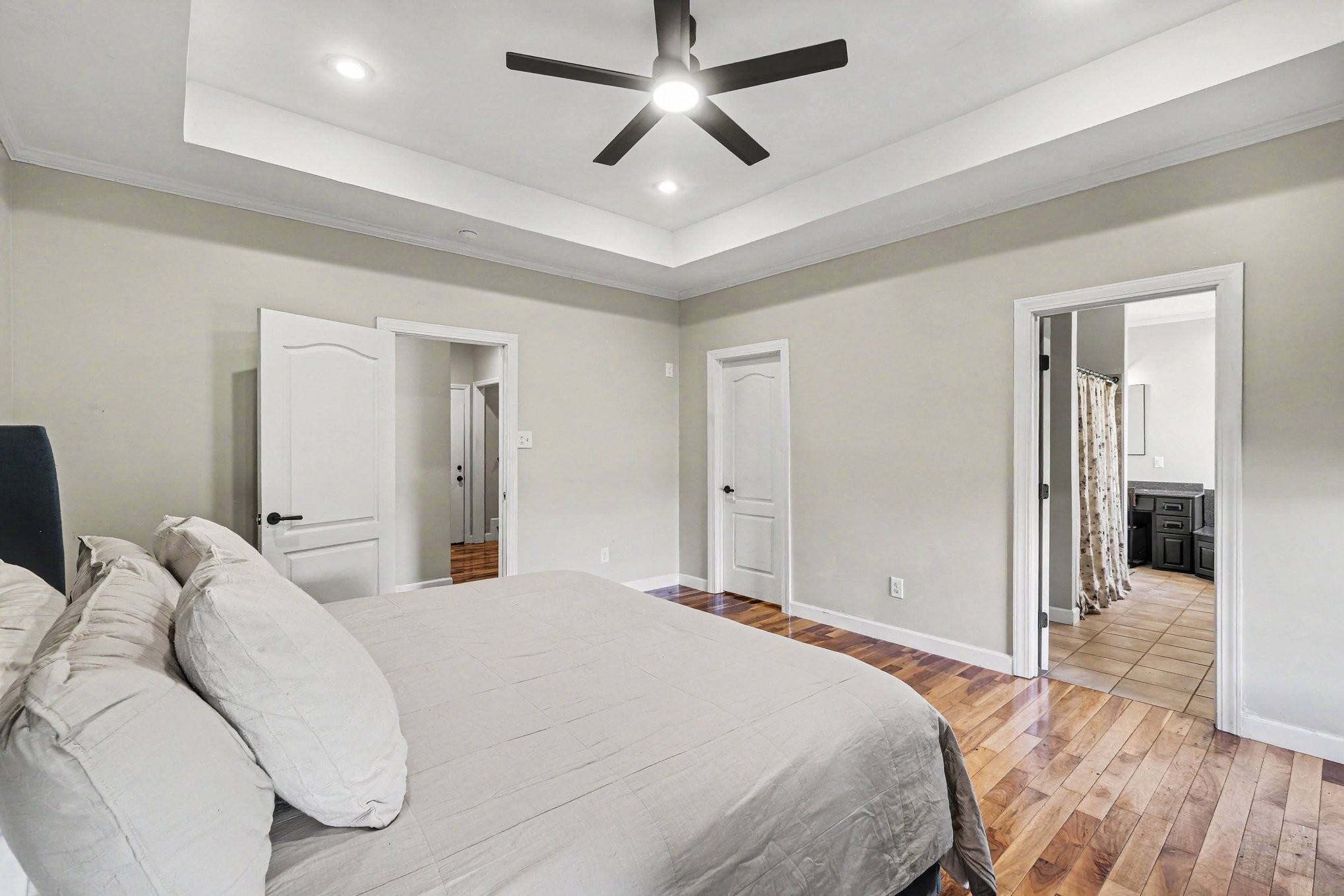 2829 Anes Station Road Lewisburg, TN 37091 - Photo 22 of 43 a bedroom with a large bed and a chandelier