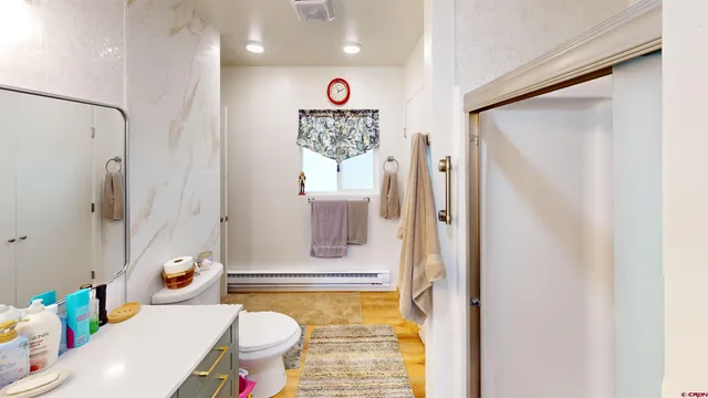 a table room with wooden floor and large windows