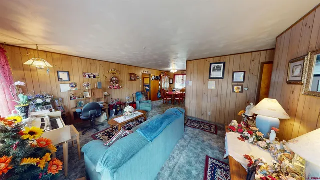 a living room with furniture and flowers