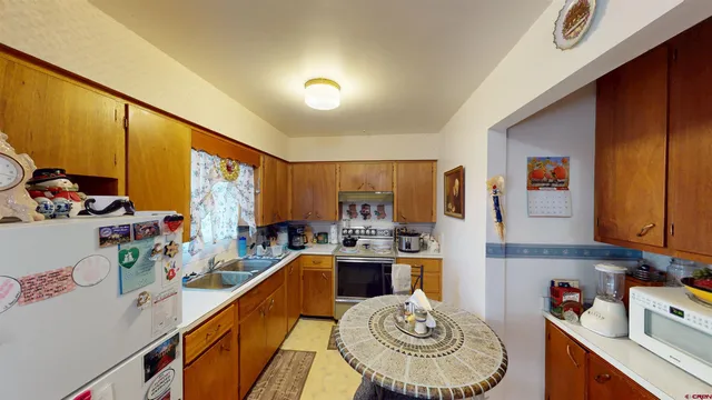 a kitchen with a sink stove and refrigerator