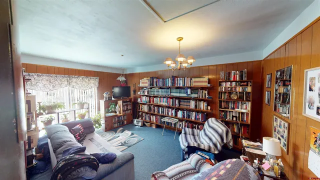 a living room with fireplace furniture and a large window