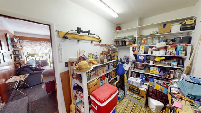 a room with furniture a rug toys and a window