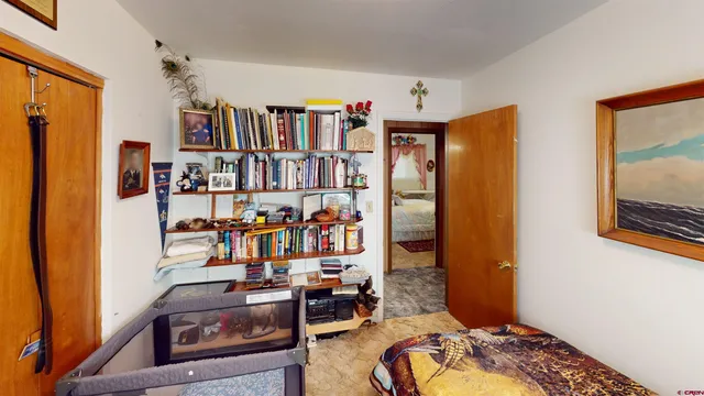 a living room with lots of furniture and a book shelf