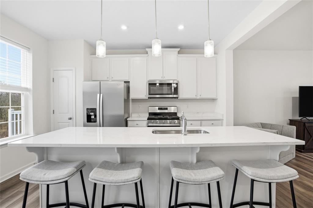237 Truth Circle Harmony, PA 16037 - Photo 22 of 48 a kitchen with stainless steel appliances a dining table chairs and a refrigerator