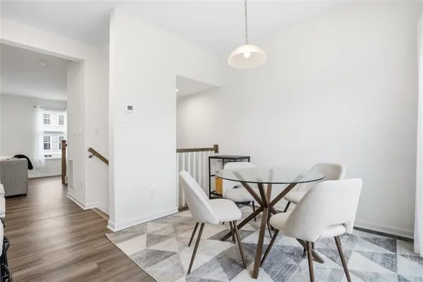 a view of a room with furniture and wooden floor