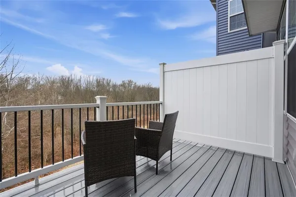 a view of balcony with wooden floor and fence