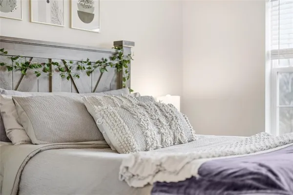 a bedroom with a bed and window