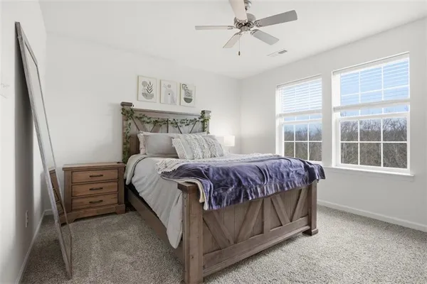 a bedroom with a bed next to a window