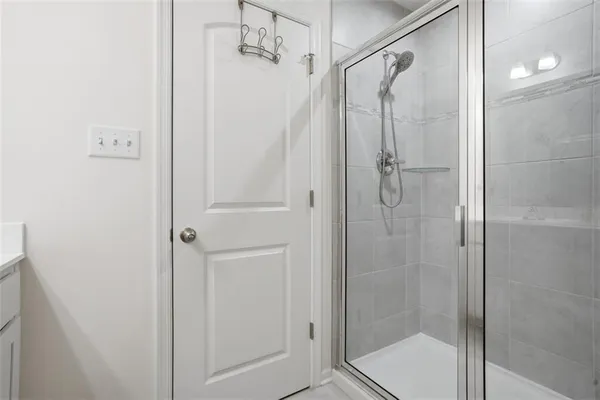 a bathroom with a glass door shower