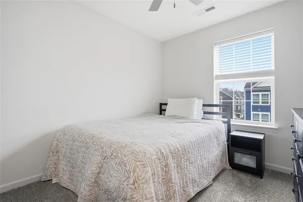 a large bed sitting in a bedroom next to a window