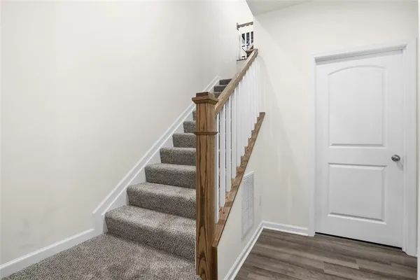 a view of entryway and hall with wooden floor