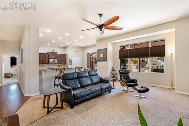 9709 Rockingham Drive Peyton, CO 80831 - Photo 8 of 50 Living area with a ceiling fan, recessed lighting, baseboards, and light colored carpet
