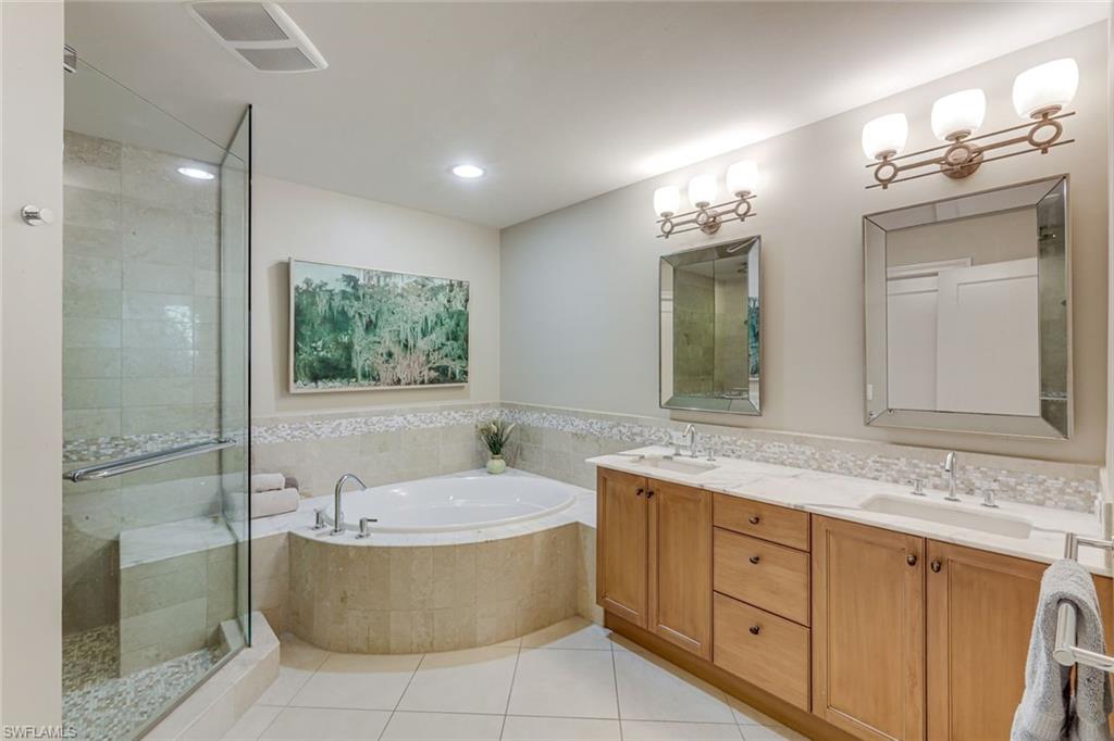 9123 Strada Place, Unit 7201 Naples, FL 34108 - Photo 14 of 50 a bathroom with a granite countertop sink mirror and bathtub