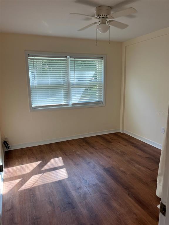 122 Northeast 37th Terrace Ocala, FL 34470 - Photo 12 of 20 an empty room with wooden floor and windows