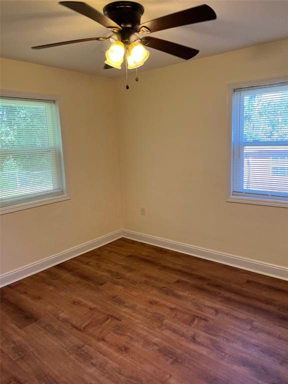 122 Northeast 37th Terrace Ocala, FL 34470 - Photo 15 of 20 a view of an empty room with wooden floor and a window