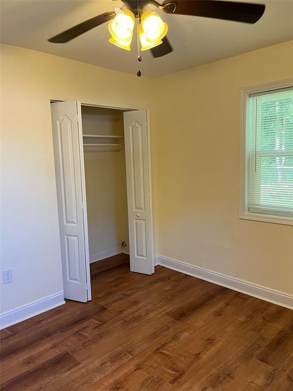 122 Northeast 37th Terrace Ocala, FL 34470 - Photo 16 of 20 an empty room with wooden floor fan and windows
