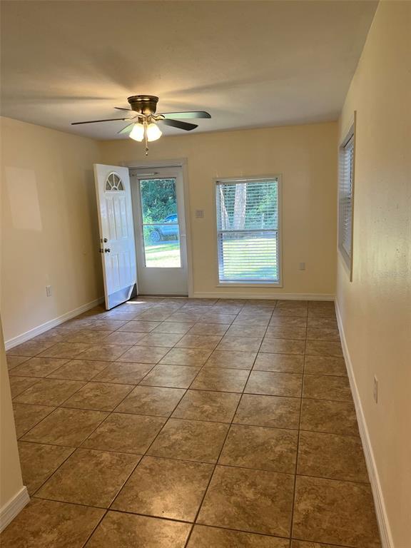 122 Northeast 37th Terrace Ocala, FL 34470 - Photo 2 of 20 a view of an empty room with window and chandelier fan