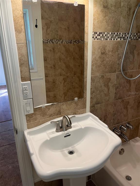 122 Northeast 37th Terrace Ocala, FL 34470 - Photo 9 of 20 a bathroom with a sink and a mirror