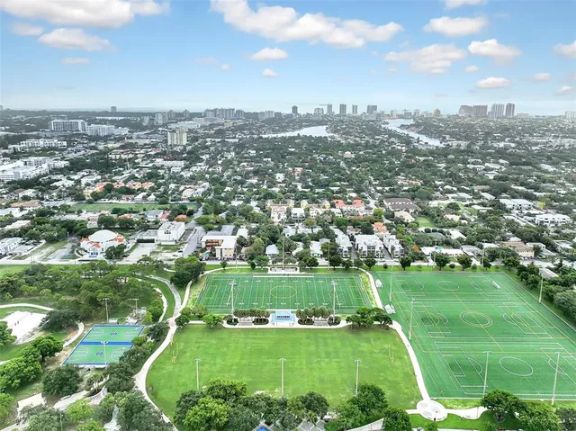 an aerial view of a houses with a yard