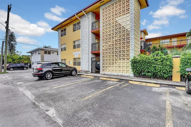 a view of a car is parked in front of a building