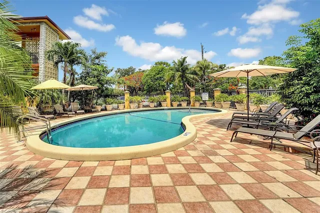 a view of a swimming pool with an outdoor seating