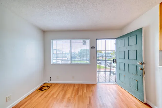 a view of a livingroom with wooden floor and a window