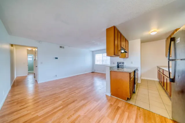a view of kitchen with furniture and wooden floor