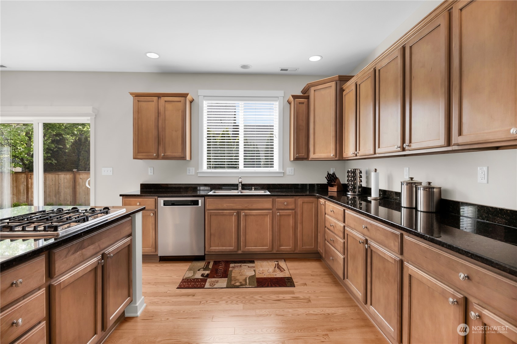 3926 216th Place Southeast Bothell, WA 98021 - Photo 9 of 31 a kitchen with granite countertop a sink stove and cabinets