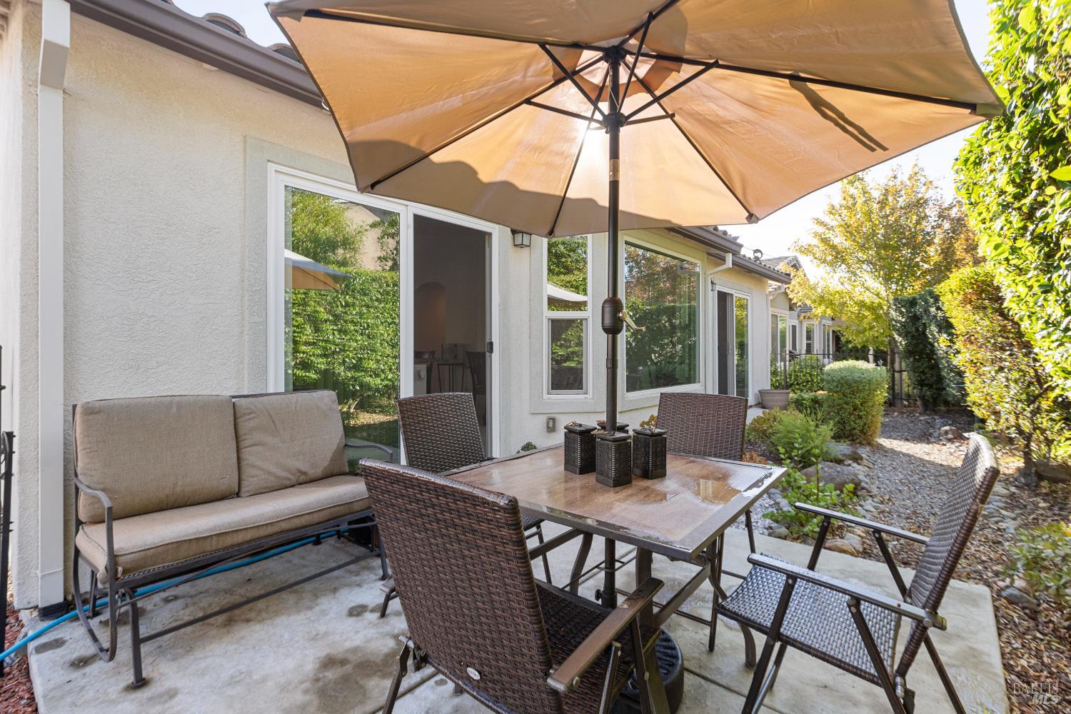 319 Birch Ridge Drive Rio Vista, CA 94571 - Photo 25 of 28 a view of a patio with a table and chairs under an umbrella