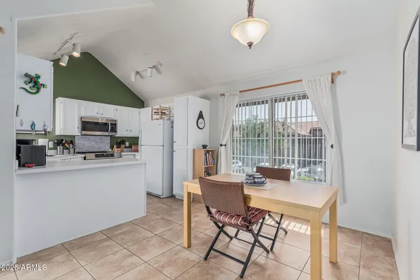a kitchen with stainless steel appliances a stove refrigerator and cabinets