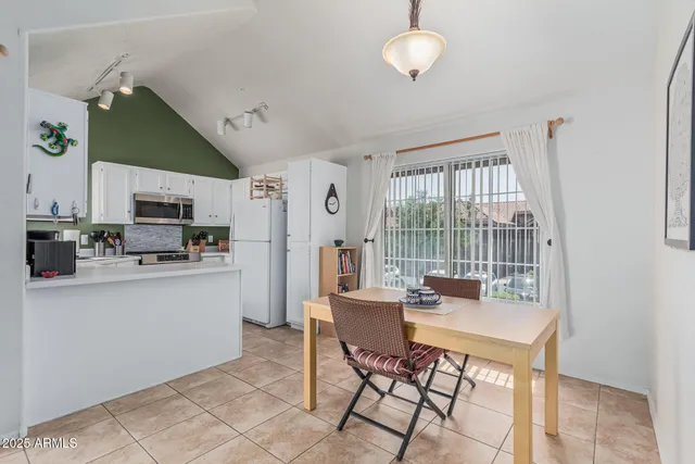 a kitchen with stainless steel appliances a stove refrigerator and cabinets