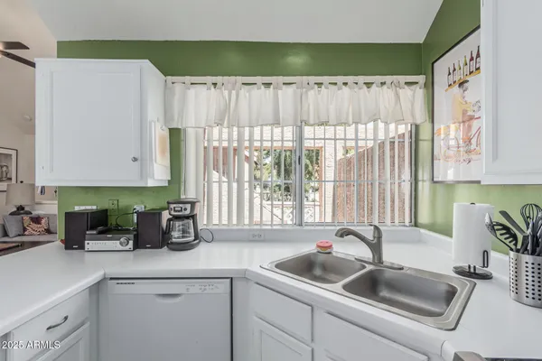 a kitchen with a refrigerator and cabinets