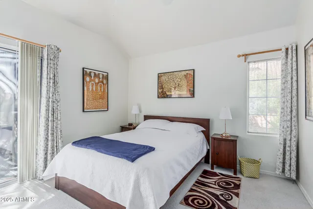 a bedroom with a bed a desk and chair