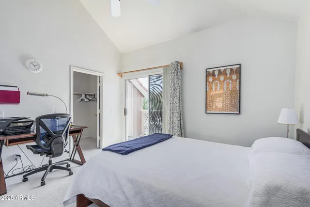 a bedroom with a bed and a painting